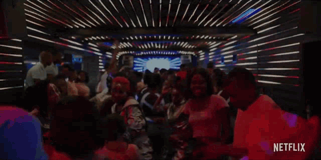 a netflix ad shows a crowd of people in a dark room