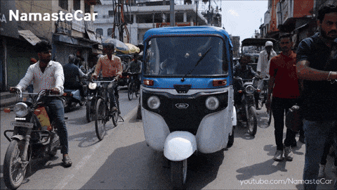 a namaste car is driving down a busy street in india