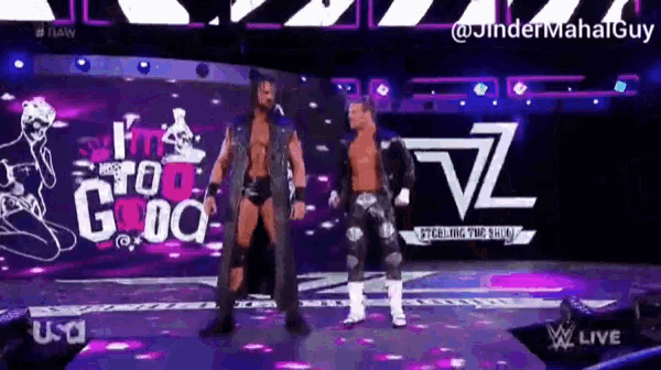 two wrestlers are standing on a stage with a sign that says i 'm too good