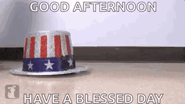 a patriotic hat is sitting on the floor with the words `` good afternoon have a blessed day '' written above it .