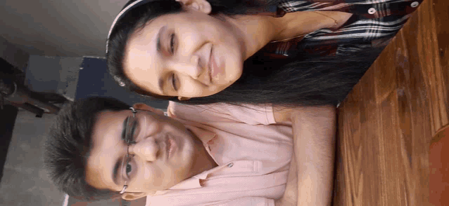 a man and a woman are posing for a picture