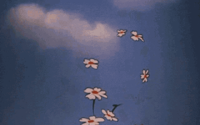 a bunch of flowers flying in the air with a blue sky in the background