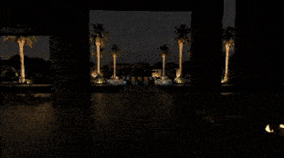 a rendering of a house at night with a pool and chairs