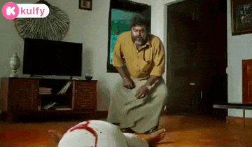 a man is kneeling down next to a woman who is laying on the floor .