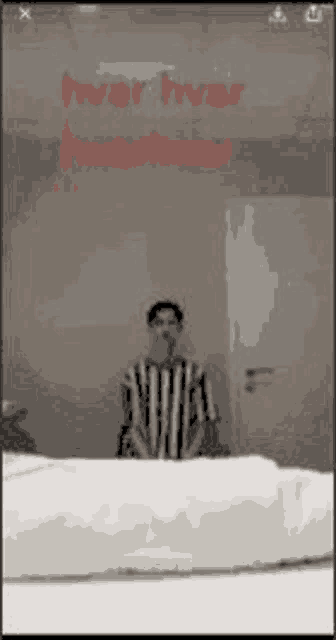 a man is standing in front of a mirror looking at himself in the mirror .