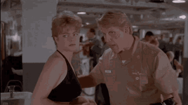 a man and a woman are standing next to each other and the man has a name tag that says ' wilson ' on it