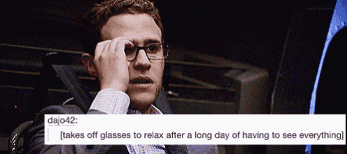 a man wearing glasses is sitting in a chair and taking off his glasses to relax after a long day of having to see everything