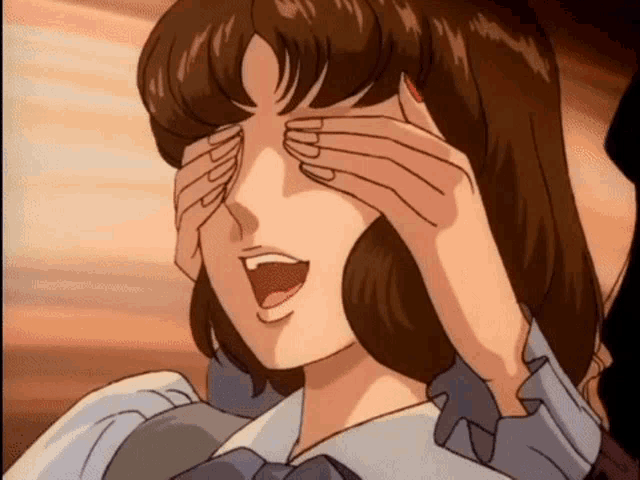 a woman is covering her eyes with her hands