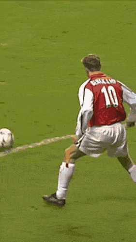 a soccer player wearing a red shirt that says ' dri ' on it is being tackled by another player