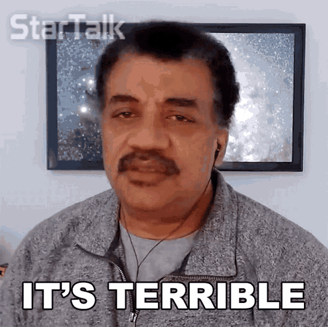 a man with a mustache says it 's terrible in front of a framed picture