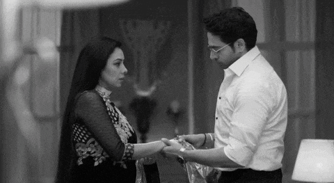 a black and white photo of a man and a woman holding hands