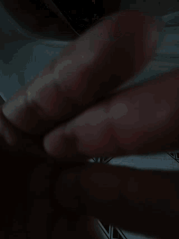 a close up of a person 's hand with their fingers extended