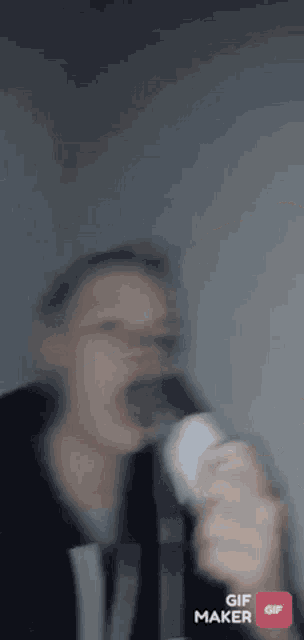 a blurry picture of a person drinking from a bottle in a gif maker app