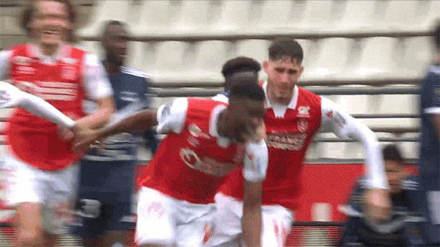 a soccer player wearing a red jersey with the word trans on the front