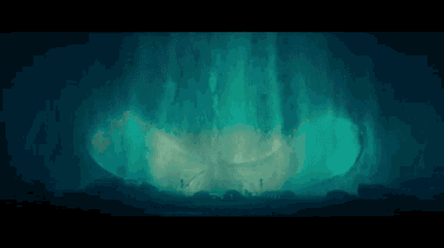 a dark cave with a glowing light coming out of it