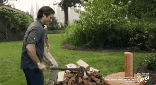 a man is chopping wood in a yard with a sign that says destination romance