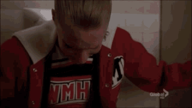 a cheerleader wearing a shirt that says vmh is crying