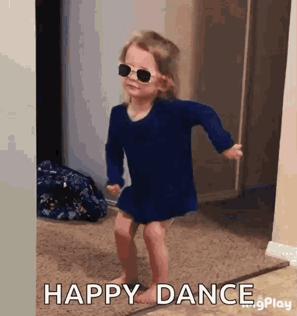 a little girl wearing sunglasses and a blue dress is dancing with the words happy dance behind her .