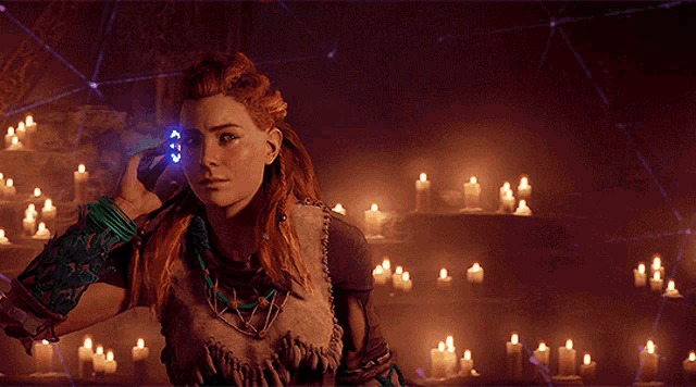 a woman with red hair is standing in front of a bunch of candles