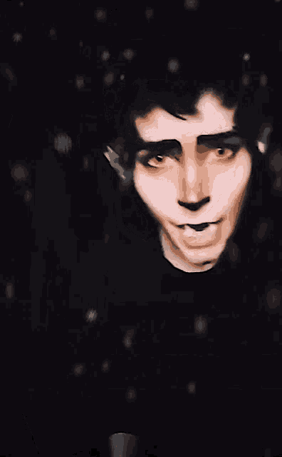 a close up of a man 's face with snow falling on it .