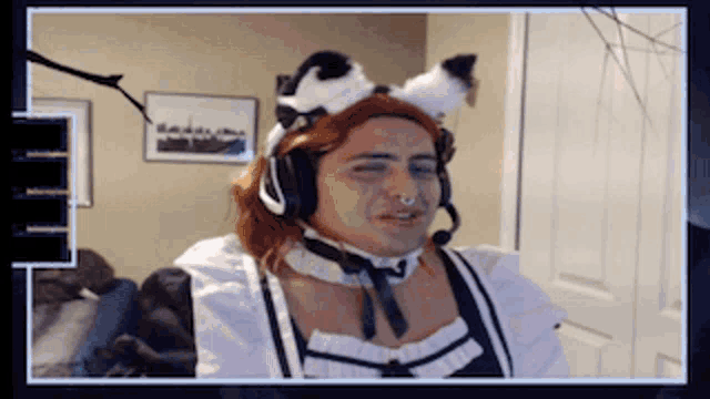 a man wearing a maid costume and a cat ear headband