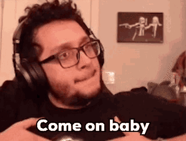 a man wearing headphones and glasses is sitting in a living room .