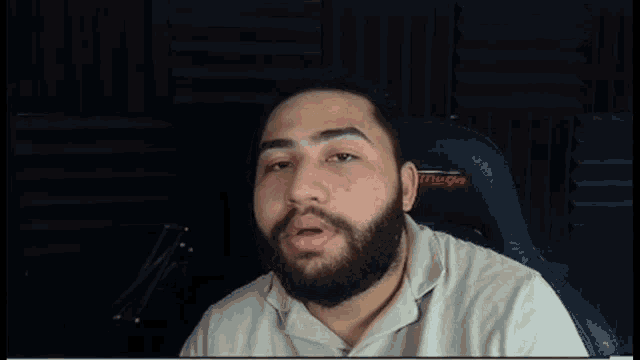 a man with a beard is sitting in a chair that says truego