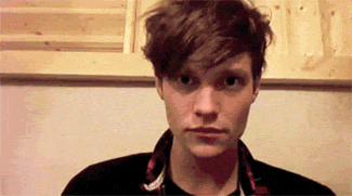 a close up of a young man 's face with a serious look on his face .