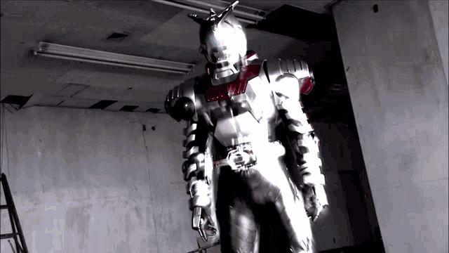 a person in a robot costume is standing in a room