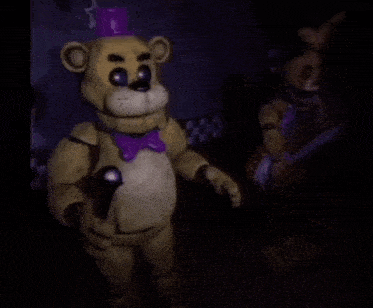 a teddy bear with a purple hat is standing next to another teddy bear .