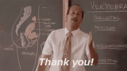 a man in a suit and tie is standing in front of a blackboard with a diagram of the female reproductive system .