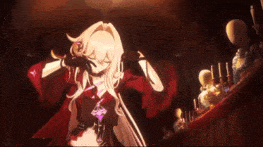 a girl in a red cape is standing in a dark room with candles .