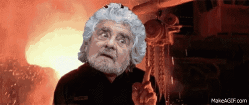 a man with gray hair and a beard stands in front of a fire