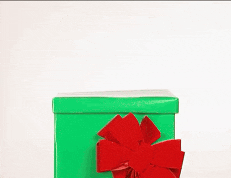 a reindeer is sticking its head out of a green christmas present box .