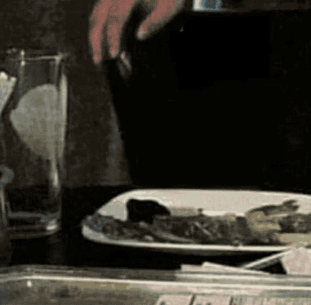 a plate of food is on a table next to a glass