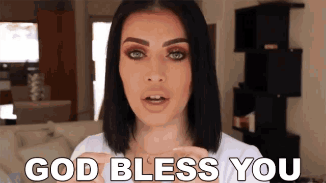 a woman is saying god bless you in a living room .