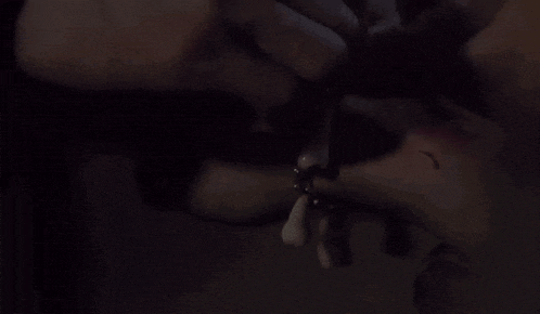 a person wearing a bracelet on their wrist with blood coming out of it