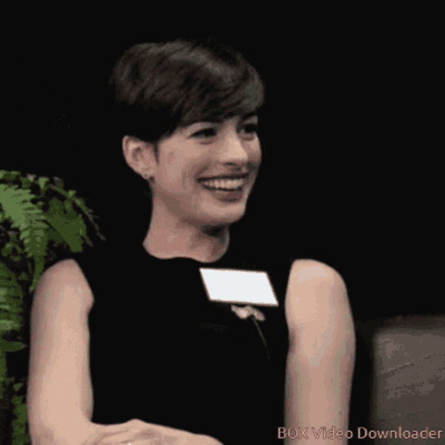 a woman is smiling in front of a black background that says i like you