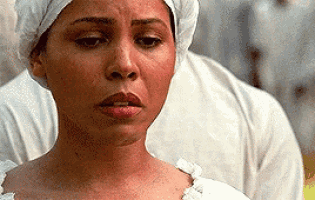 a close up of a woman wearing a white head scarf .