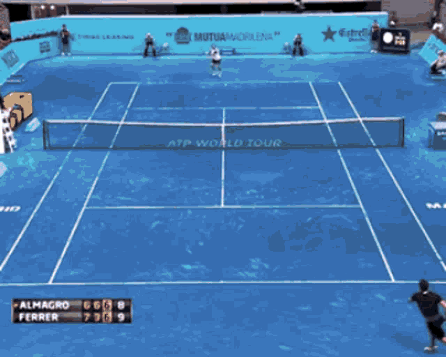 a man holding a tennis racquet in front of a scoreboard that says almagro