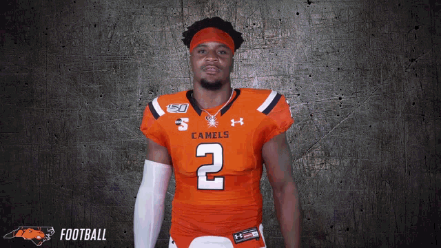 a man wearing an orange jersey with the number 2
