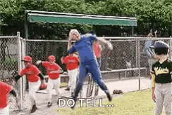 a man in a blue suit is jumping in the air while playing baseball with a group of children .