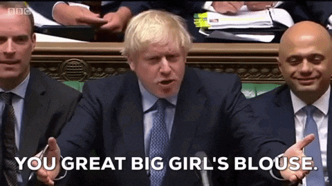 a man in a suit and tie is talking into a microphone and says " you great big girl 's blouse " .