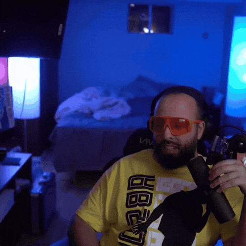 a man wearing sunglasses and a yellow shirt that says hbo
