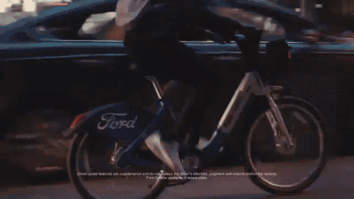 a person is riding a bike with a ford logo on it