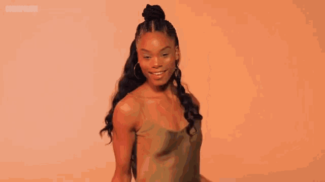 a woman 's hair is in a bun with the words cosmopolitan on the bottom right