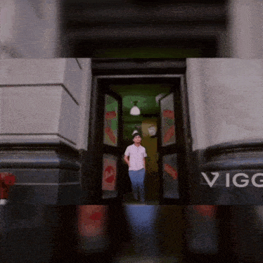a person standing in a doorway with vigo written on the bottom