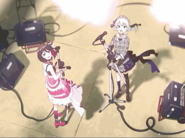two anime girls singing into microphones on a stage with a shadow of a person behind them