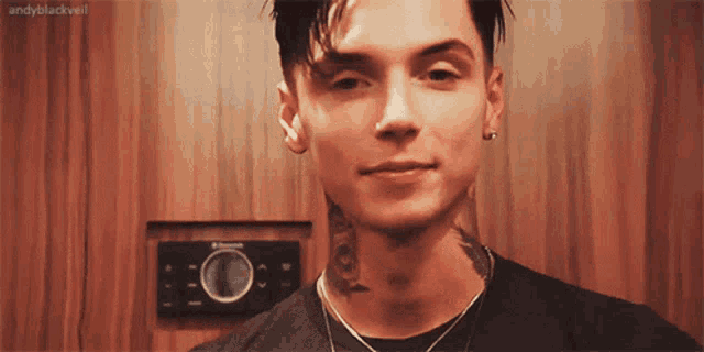 a close up of a man 's face with a tattoo on his neck .