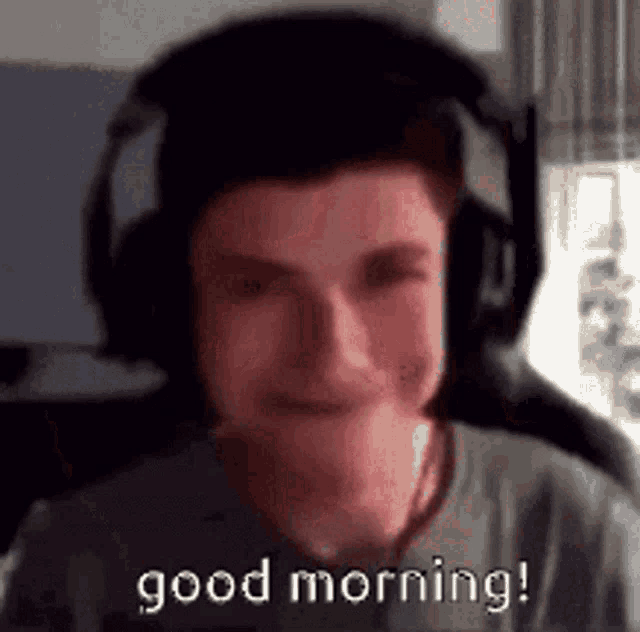 a man wearing headphones is smiling and says `` good morning '' .